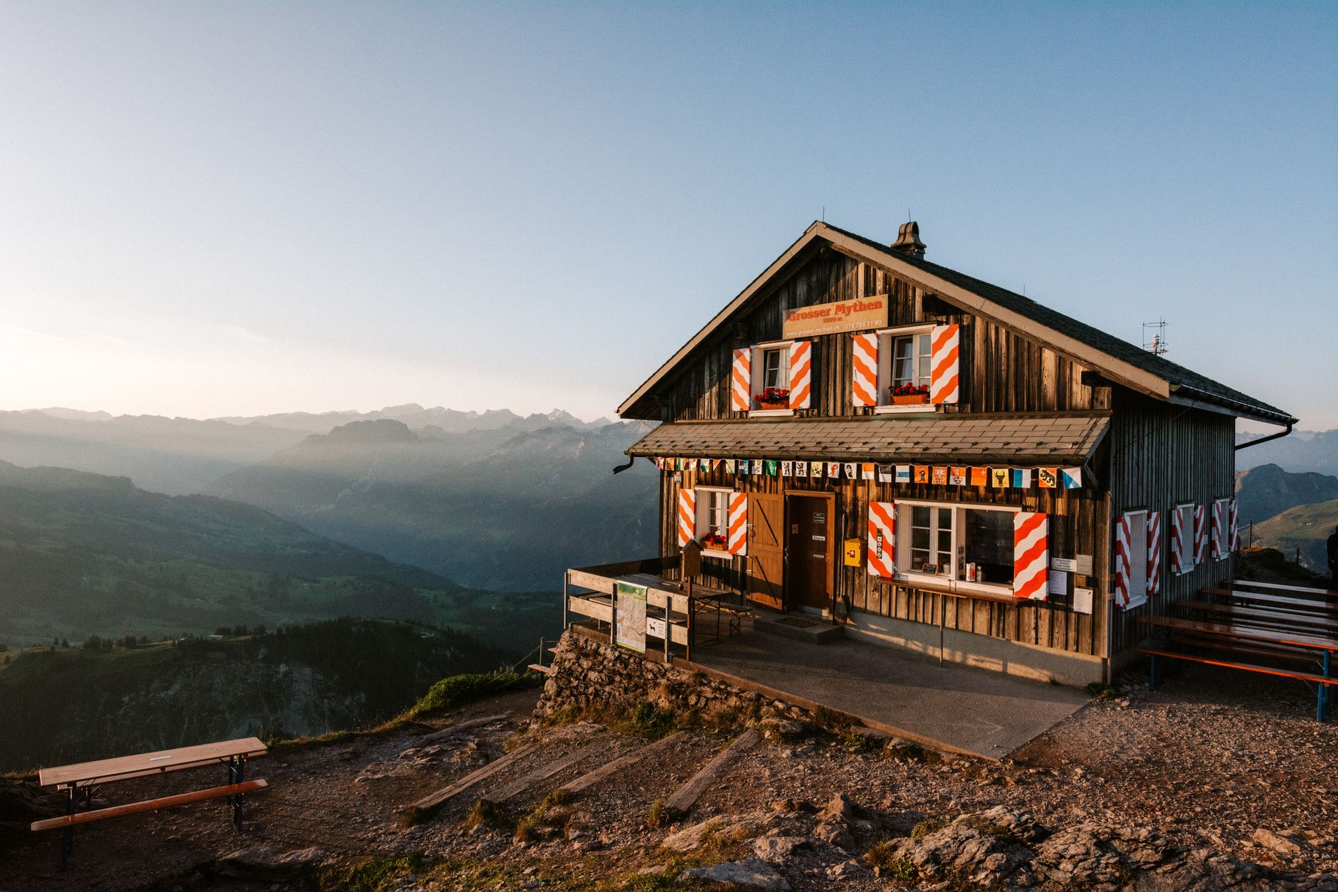 Sunrise light on peaks above an alpine hut