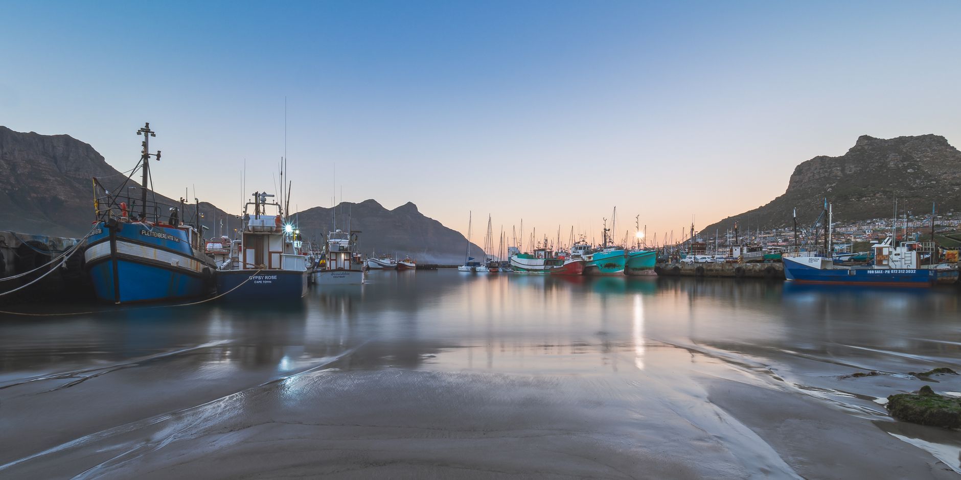 Fishing boats resting in a harbour at dawn