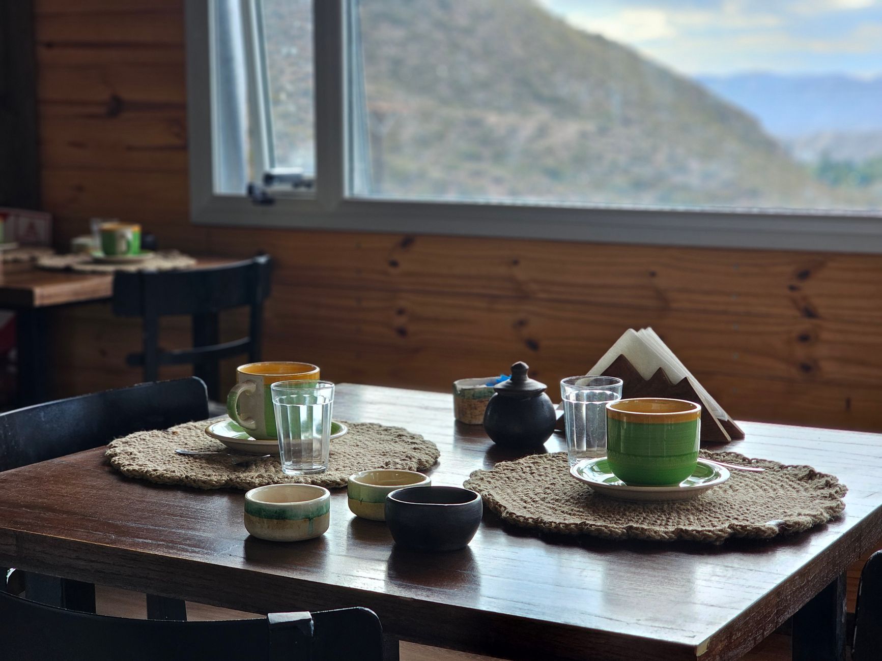 A wooden breakfast table inside a mountain hut