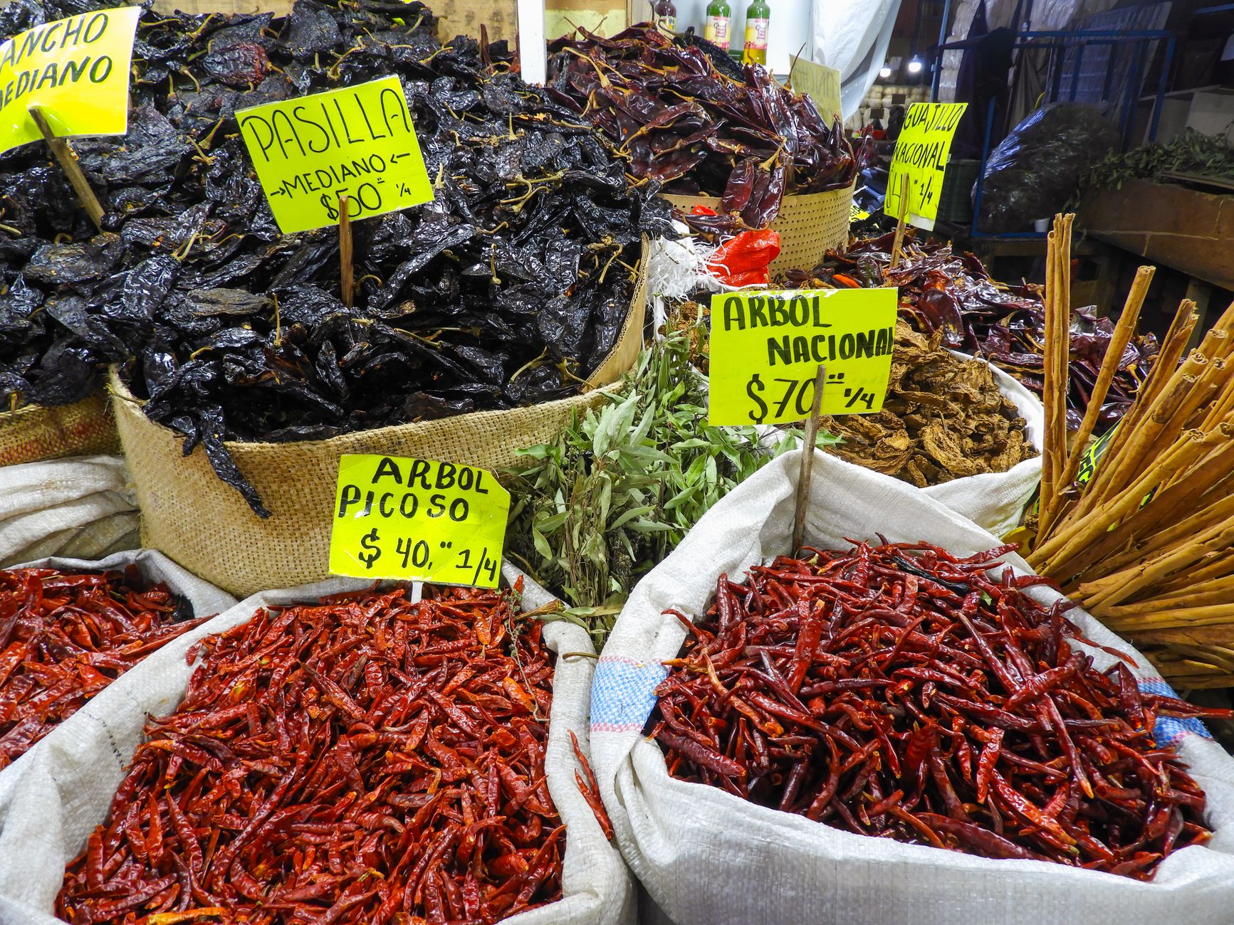 Dried chiles heaped in baskets at a market